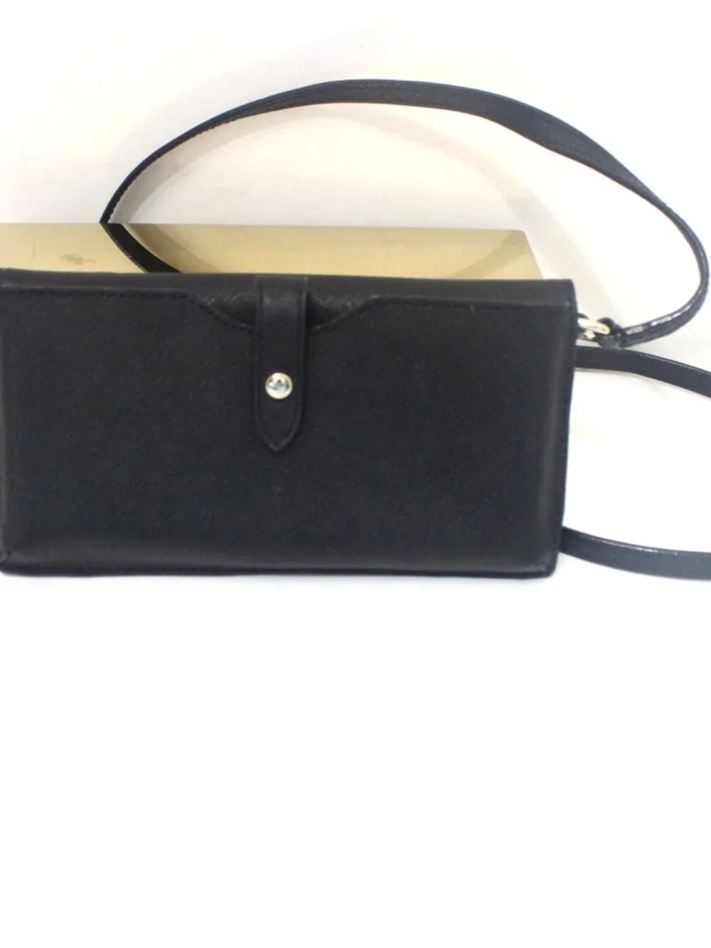 The Kate Spade Bifold Wallet/Crossbody in Black Saffiano Leather is a stylish an